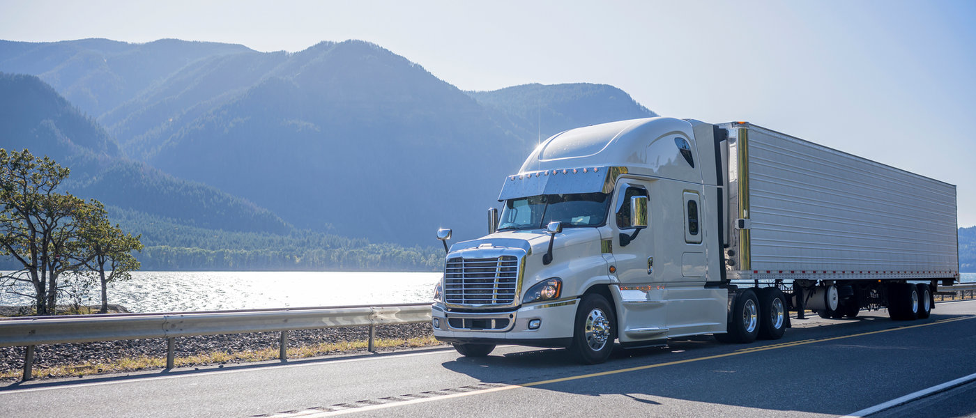 Truck driving by a lake